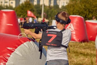 Мальчик в жилете "Red Team" с автоматом LASERWAR