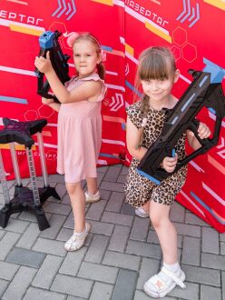 Две девочки с футуристическими автоматами LASERWAR позируют.