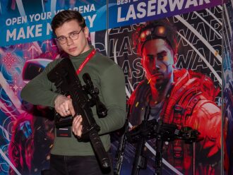 Молодой человек с винтовкой LASERWAR на презентации
