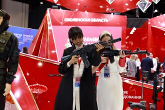 Две девушки с лазертаг-автоматами на выставке 2026