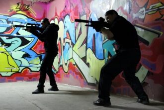 Два бойца LASERWAR в темной одежде с оружием